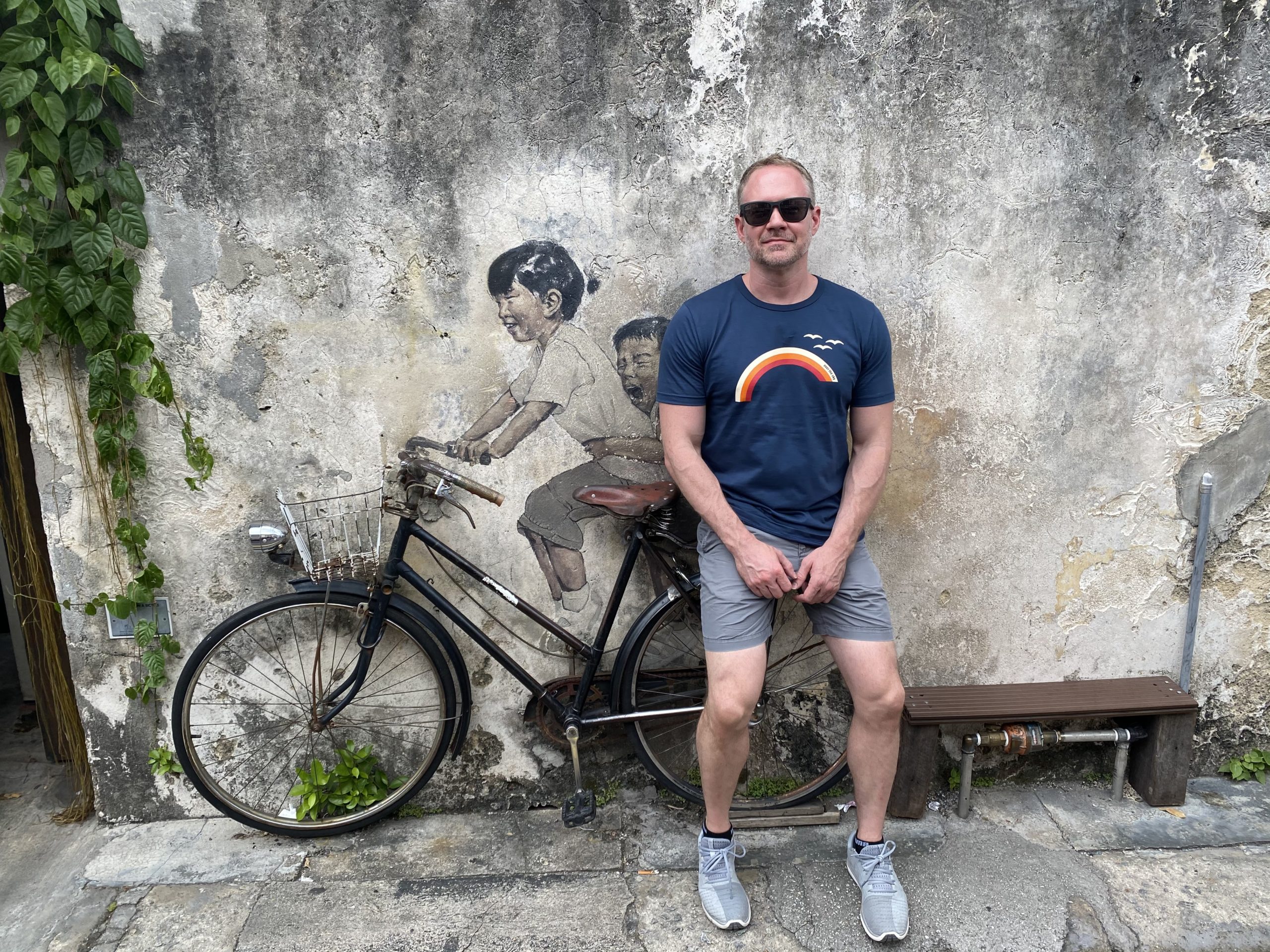 Jeremy_Thompson.4 Jeremy Thompson standing in front of a painting mural.