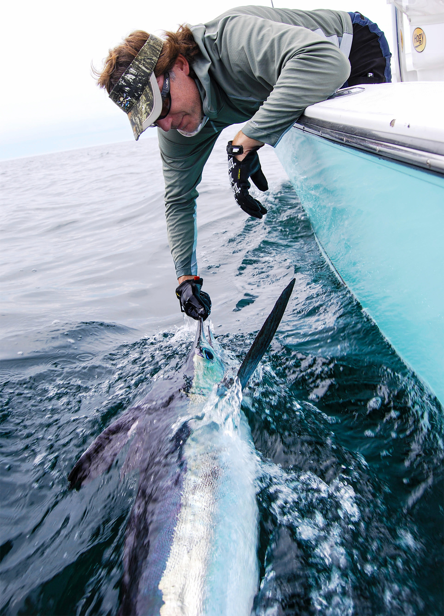 Dave Morel pulling a white marlin boatside.